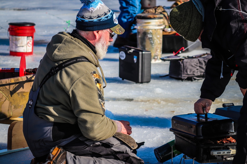 people ice fishing fisheree winter river